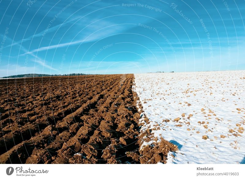 Blue - Brown - White - the colors of winter! Fallow field - ploughed field - deep blue winter sky with tender cloud stripes Winter sky brown field CROSSED