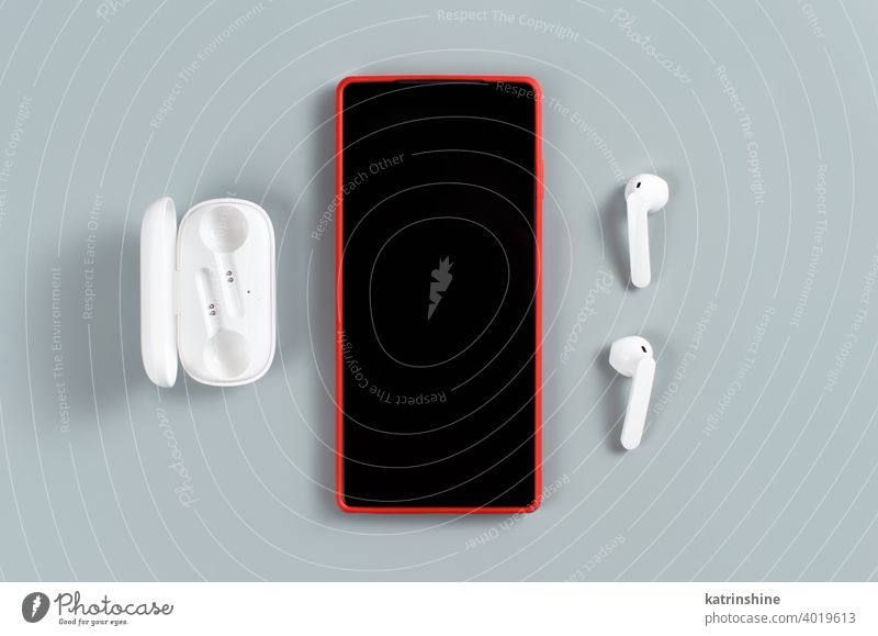 Red Cell phone and white wireless earphones smart phone cover mockup top view background Headphones Accessories Portable Mobile cell phone camera phone