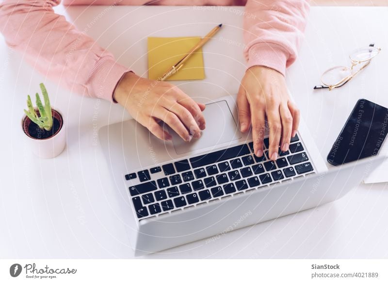 Woman hands working at laptop on a white marble desk. woman person table female library wooden pen young business view background morning girl adult lifestyle