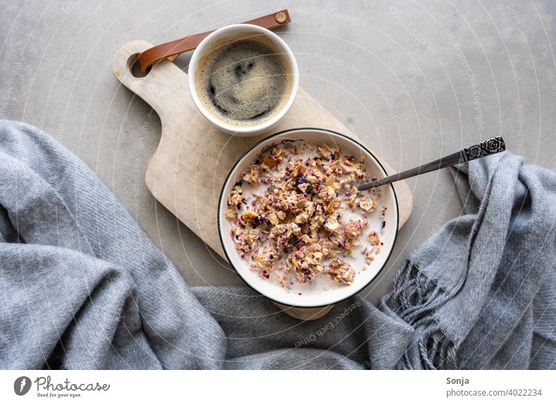 Muesli with milk in a bowl and a cup of coffee. Healthy breakfast. Cereal Milk Bowl Breakfast Coffee Chopping board Wood porridge Healthy Eating Rustic Vitamin