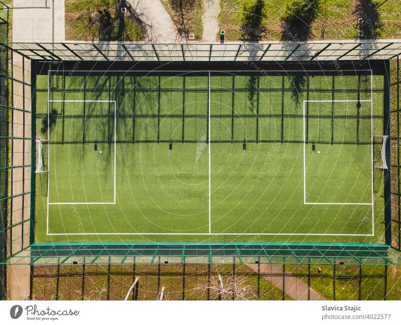 Drone View Of Street Soccer Court. Outdoor sport ground with green surface for playing football  or soccer  in urban area, detail, drone view activity