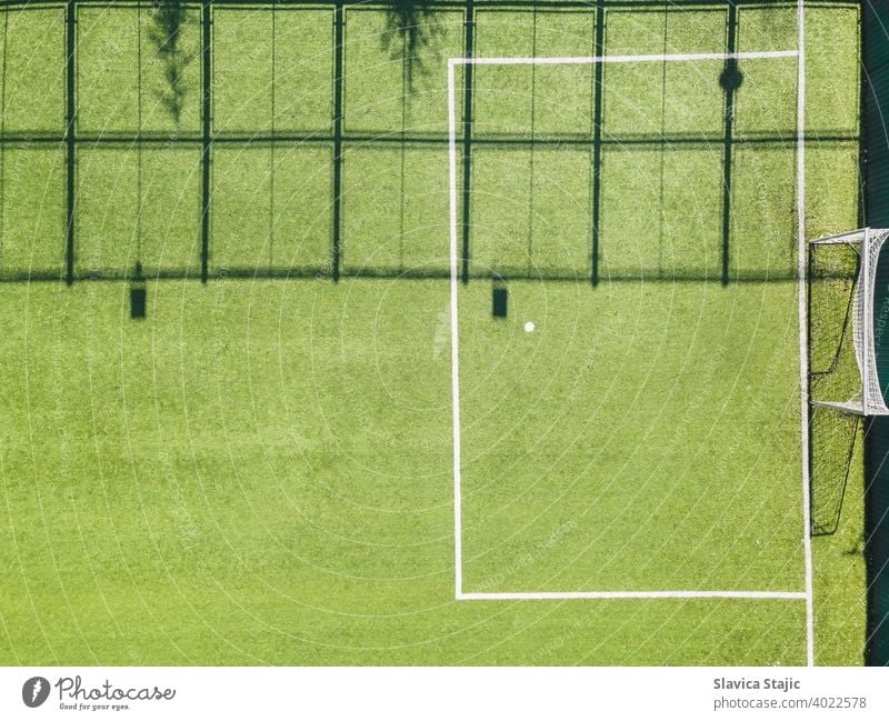 Green Urban Soccer Court. Outdoor sport ground with green surface for playing football  or soccer  in urban area, detail, drone view activity artificial