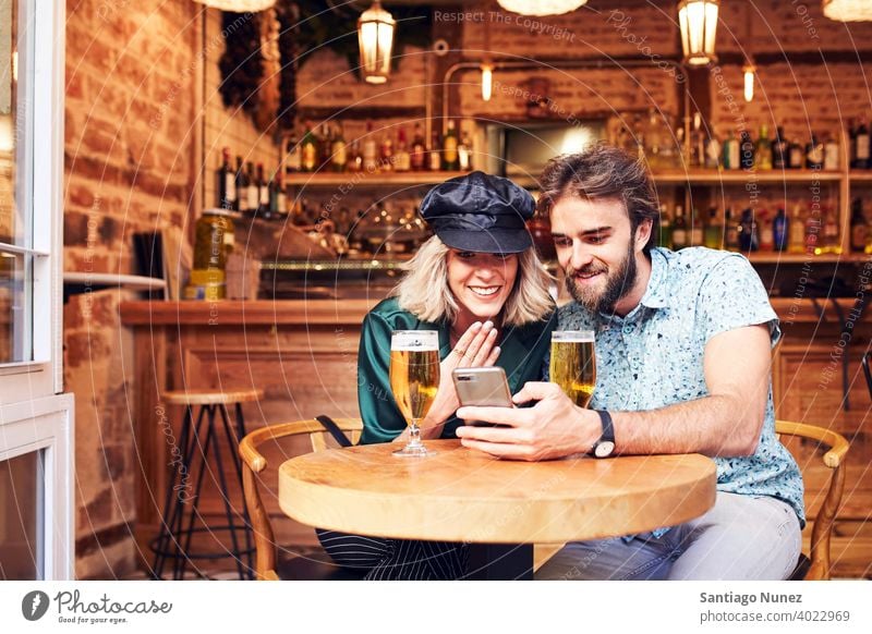 Caucasian couple having a drink at a bar. adult woman people happy female lifestyle two caucasian beautiful together smile love joy boyfriend indoors romance