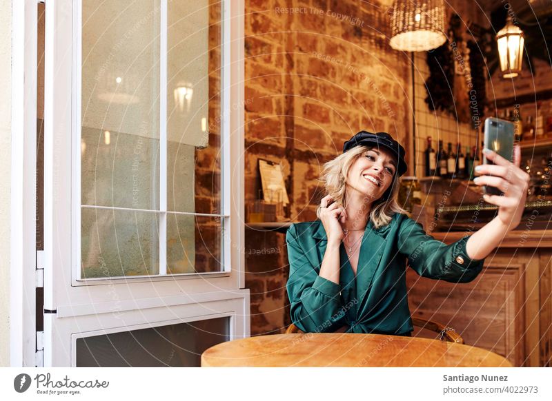 Woman taking a selfie at a bar. adult woman happy female restaurant lifestyle caucasian beautiful happiness smile fun love joy celebration dating romantic