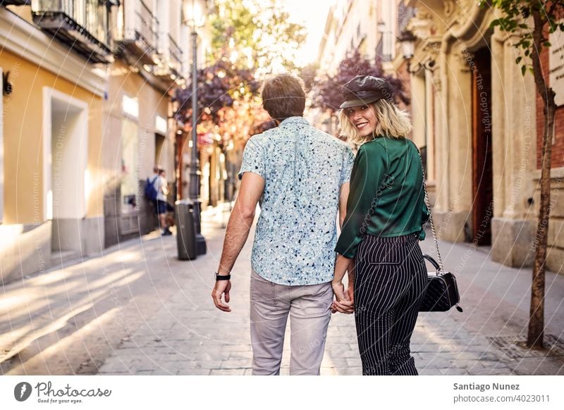 Couple walking on street away from camera. couple adult woman people happy female lifestyle two caucasian beautiful happiness together drink smile fun love joy