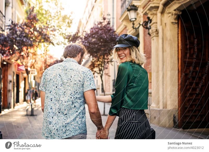 Couple walking on street away from camera. couple adult woman people happy female lifestyle two caucasian beautiful happiness together drink smile fun love joy