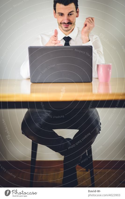 good humored man sitting in front of a laptop Man Good mood Positive optimistic contented home office at home Workplace Quarantine Notebook labour Online