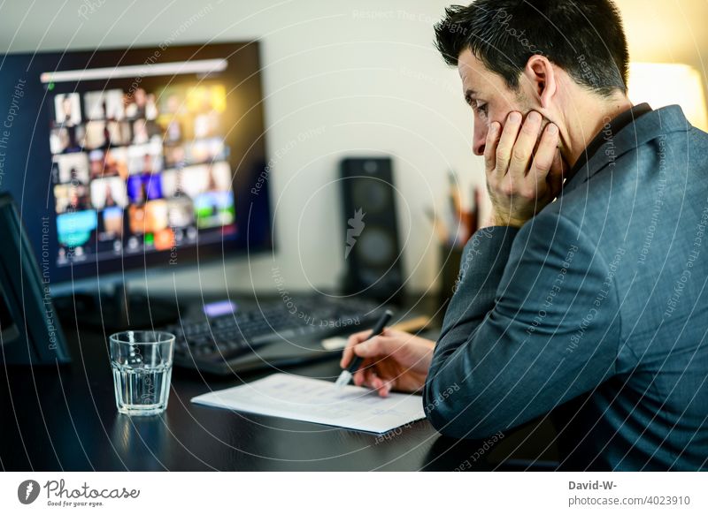 Man sits at the computer and checks data on a piece of paper Computer labour Piece of paper pen keep tabs on sb./sth. test List