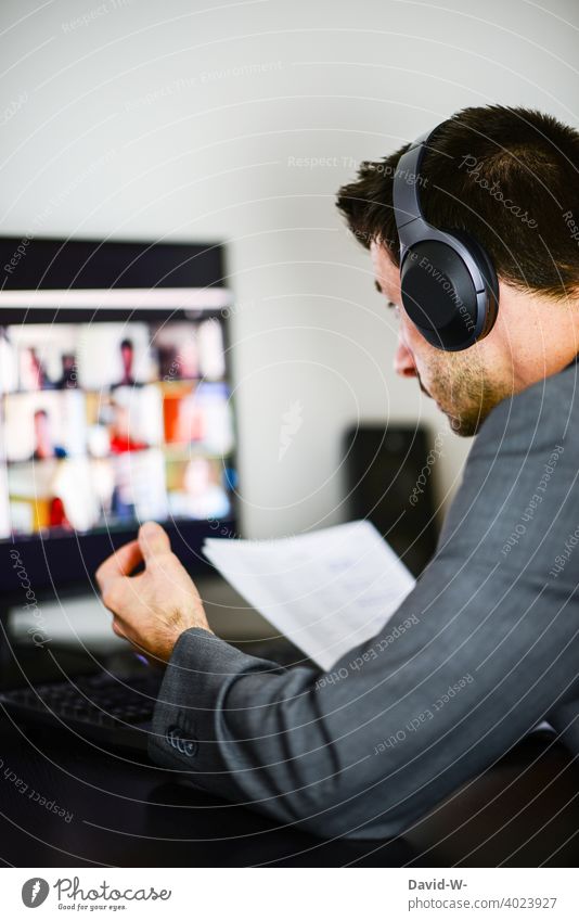 Discussion in the video conference in the home office Video conference Discussion round discussion business Man labour Internet Computer laptop Headset