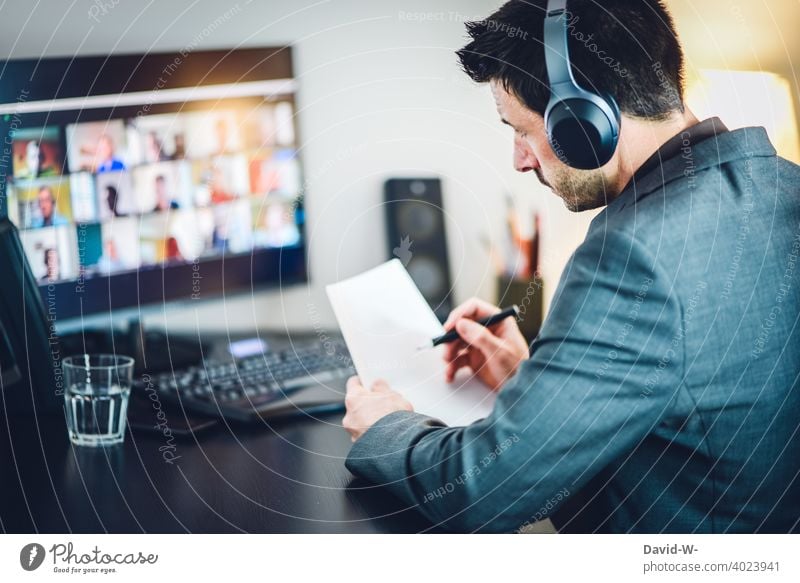 Man in online meeting working at a desk on a computer Online labour Computer home office Workplace Discussion Digital laptop Desk Office Business