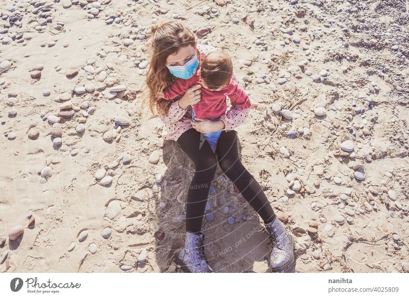 Happy family moment of a young mom enjoying a day on the beach with her baby love holidays happiness lifestyle sun sunny summer trendy fashion mother parenthood