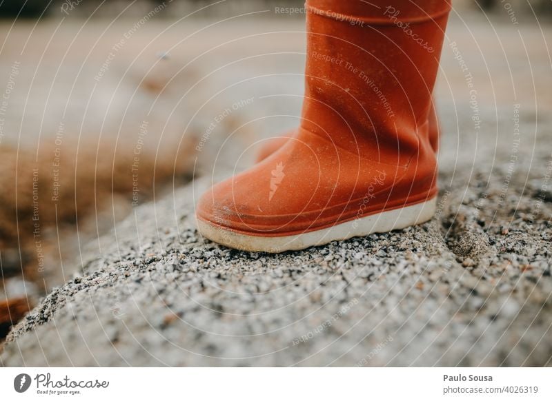 Child red rubber boots Red Rubber Rubber boots Feet shoes Boots Rain Exterior shot Wet Footwear Weather Water Dirty Human being Joy Legs Copy Space Colour photo