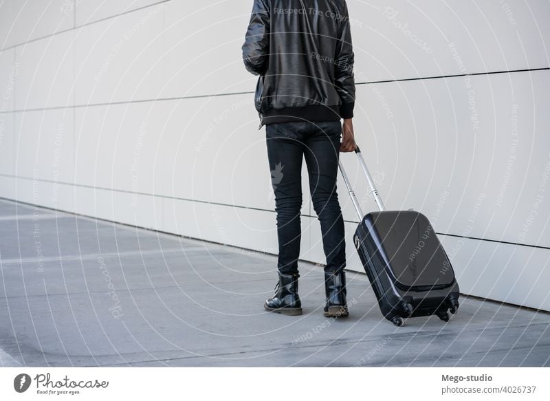 Tourist man carrying suitcase while walking outdoors. travelling tourist traveler destination concept holiday joy enjoy adventure traveller vacations portrait