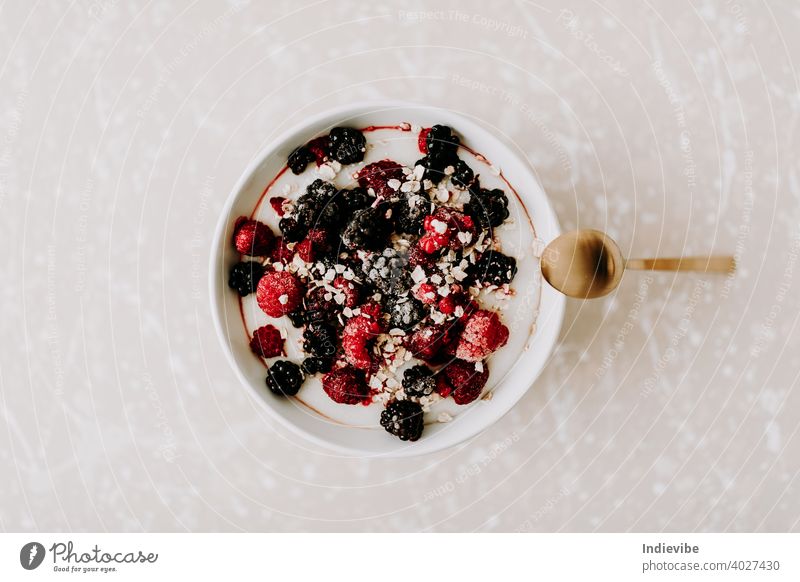 Healthy porridge breakfast with frozen fruit and strawberry syrup. Sugar and lactose free vegan or vegetarian option. oat sweet fresh healthy delicious