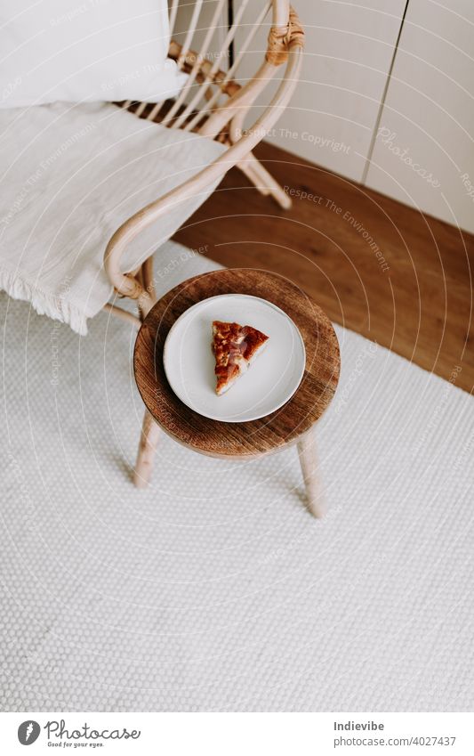 A slice of home made apple pie on a wooden stool in a living room vanilla dessert cake sweet food fruit warm delicious tasty sugar free gluten vegan vegetarian