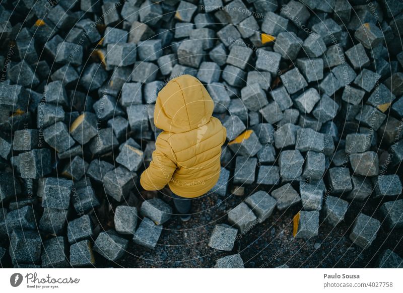 Toddler playing with rocks explore Yellow Child Rear view Infancy Exterior shot Nature Colour photo Leisure and hobbies Adventure Day Human being Boy (child)