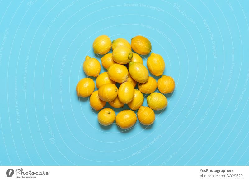 Pile of lemons isolated on a blue background. Fresh lemons above view. bunch citrus citrus fruits copy space cut out detox diet farmers market flat lay food