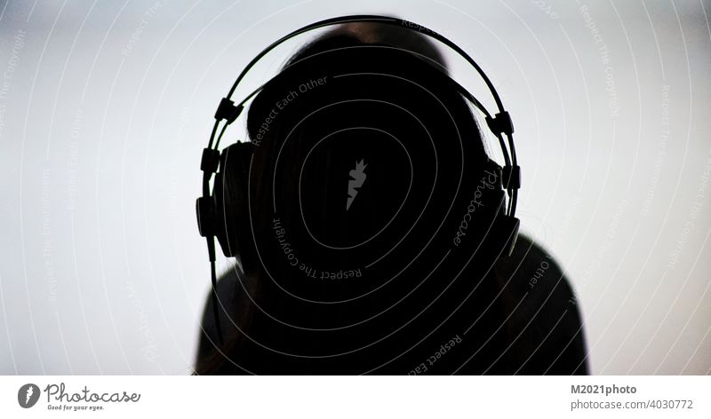 A person seen from behind with headphones woman silhouette music hair female fashion earphone beautiful listen move player enjoy fun entertainment modern white