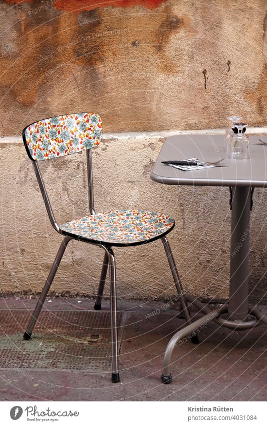 pretty patterned chair in street café Chair Table Sidewalk café out Street Wall (building) Facade kitchen chair Retro vintage Bistro Restaurant Gastronomy urban