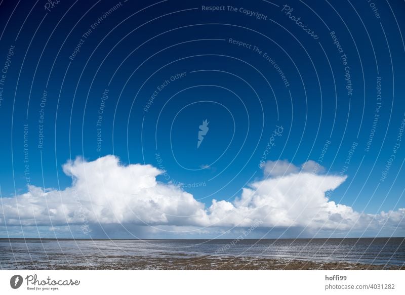 blue sky and clouds with rain over an island Clouds Symmetry Rain Island Blue sky Beach coast Water Ocean Sky Vacation & Travel Landscape Summer Nature