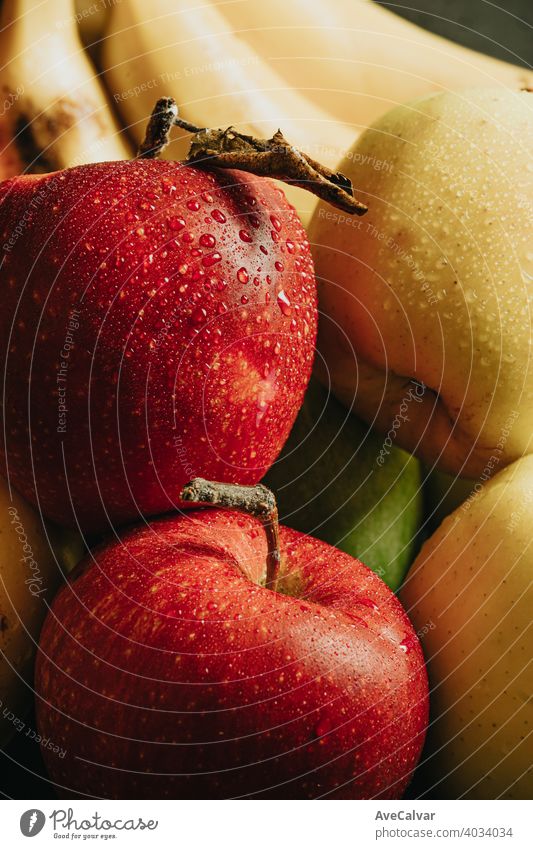 Close up of healthy fruits with a very delicious aspect apples and bananas with water dropsClose up of healthy still life fruits with a very delicious aspect apples and bananas with water drops