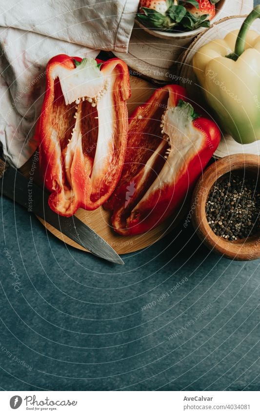 Mock up of a cooking table with a pepper cut in half a knife and some condiments canvas mock up carrots old wood horizontal produce color image cookery fiber