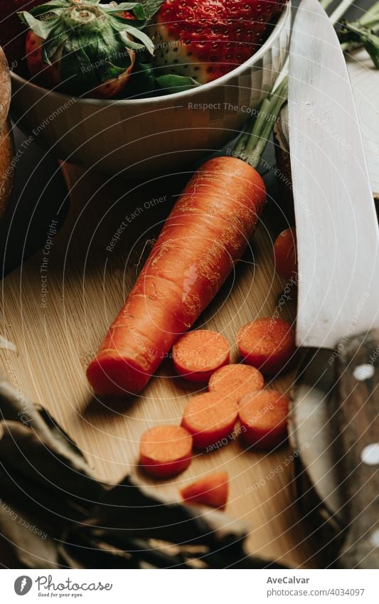 Still life concept shot of spanish cooking with a carrot and different accesories for the kitchen canvas knife mock up carrots old wood horizontal produce