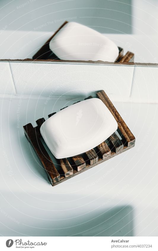 A hard soap over a soap dish in a white toilet bathroom shower clean wash background hygiene closeup texture spa health care water beauty cosmetics healthy