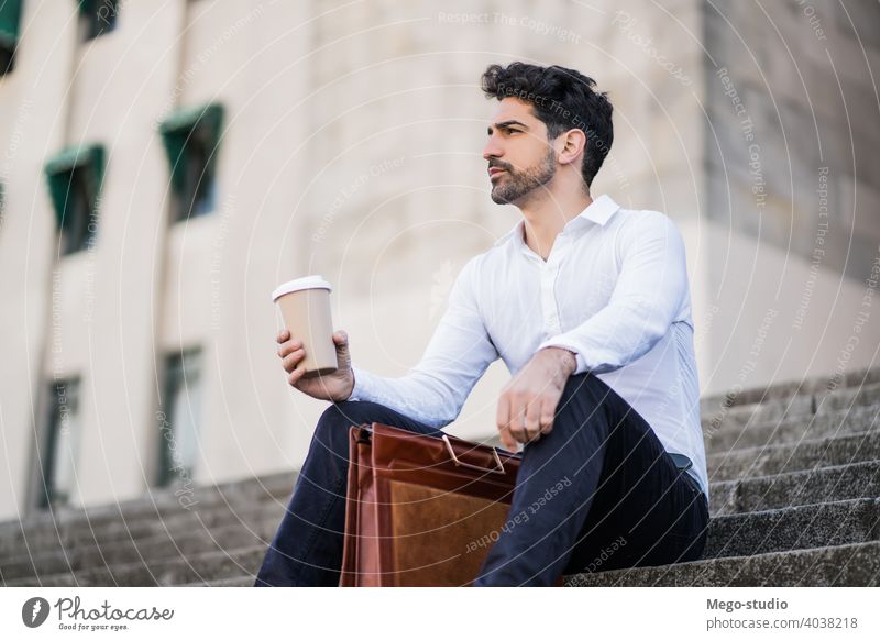 Business man drinking coffee on a break from work. young business cup outdoors street city urban life stylish hold hot career cafe employee outside portrait