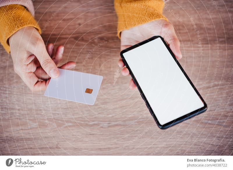 unrecognizable happy caucasian woman in terrace using mobile phone device and credit card for online shopping. Technology and lifestyle concept terrace outdoors