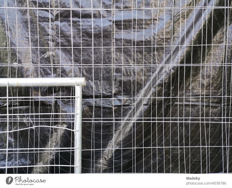 Construction fence made of wire with privacy screen made of black foil at the Goethe University in Frankfurt am Main Bockenheim in Hesse Hoarding cordon