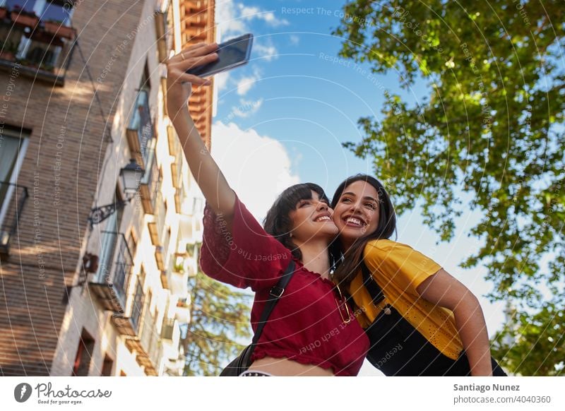 Two teenager girls taking a selfie. madrid young people friendship lifestyle beautiful fun happy together leisure woman smiling teens cheerful female youth