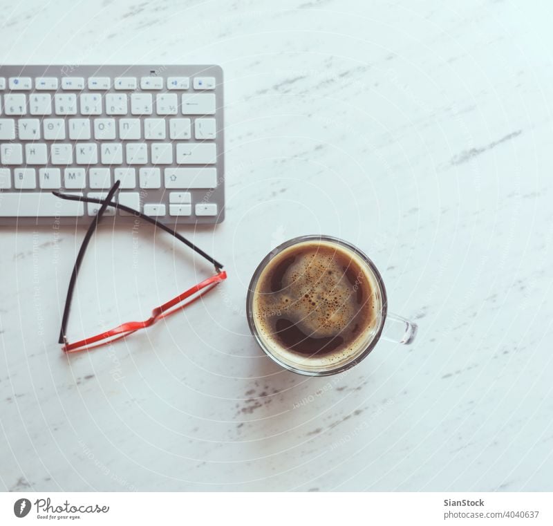 Workplace with glasses, coffee and keyboard. laptop desk view table office computer cup desktop white above work business background space workplace technology