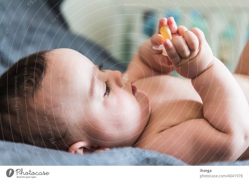 portrait of adorable baby lying babycare babyhood beautiful beauty boy caucasian child childcare childhood closeup cute emotion excitement expression eyes face