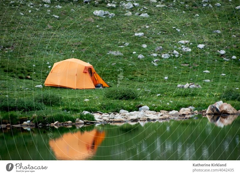 Orange Tent Campsite camp camping tent orange Green Nature rocky mountains water lake pond reflection Summer Spring Season Seasonal adventure countryside