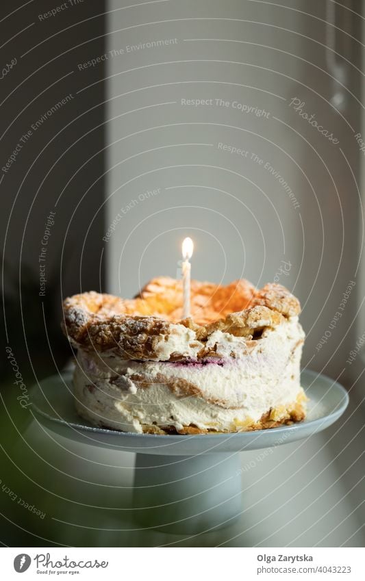 Polish Carpathian Mountain Cream Cake with birthdate candle. dessert karpatka cream birthday cake polish stand homemade morning rustic white pastry holiday