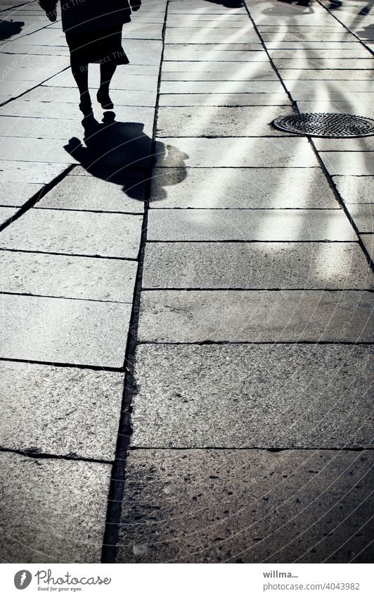 Running. Shadow Human being person Woman Senior citizen Going Light and shadow Boulevard walkway slabs Pedestrian precinct on one's own manhole cover