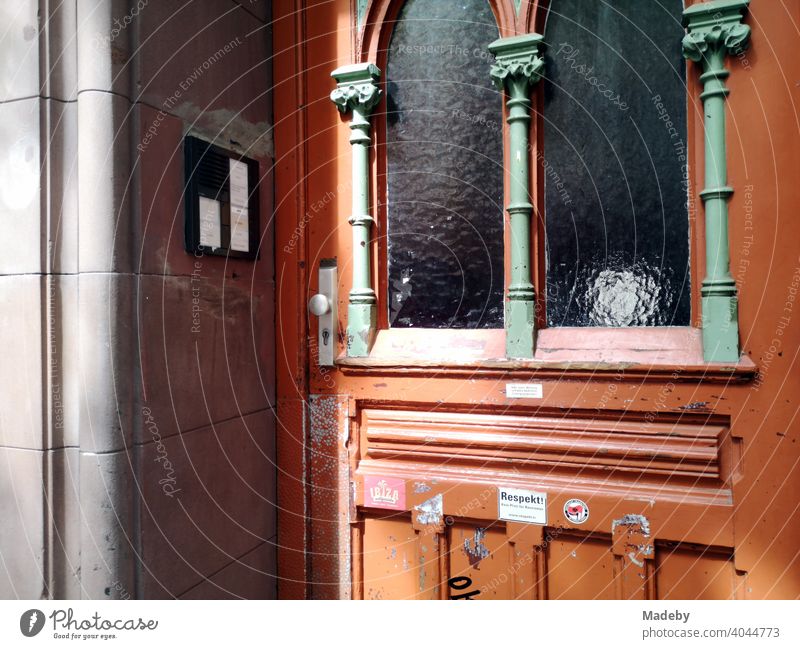 Beautiful old wooden door with art nouveau ornaments and fluted glass in sunshine in the north end of Frankfurt am Main in Hesse front door Wooden door