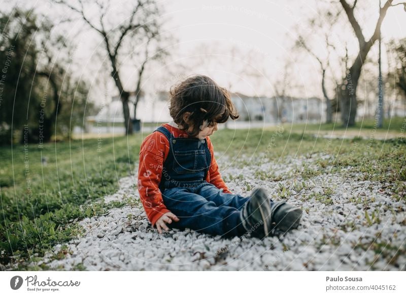 Child playing in the park Caucasian 1 - 3 years Girl Spring Park Lifestyle Infancy Colour photo Exterior shot Toddler Leisure and hobbies Nature Playing