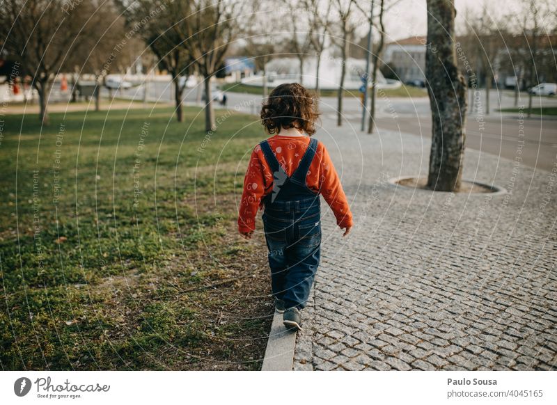 Rear view child walking on the sidewalk Sidewalk Pavement Child Walking 1 - 3 years Playing Day Toddler Exterior shot Human being Colour photo Infancy