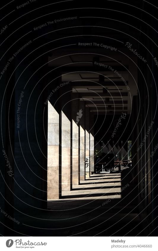 Arcade with columns of light sandstone and sloping shadows in the summer sunshine at the Weißfrauenstraße in Frankfurt am Main in Hesse portico Column Underpass