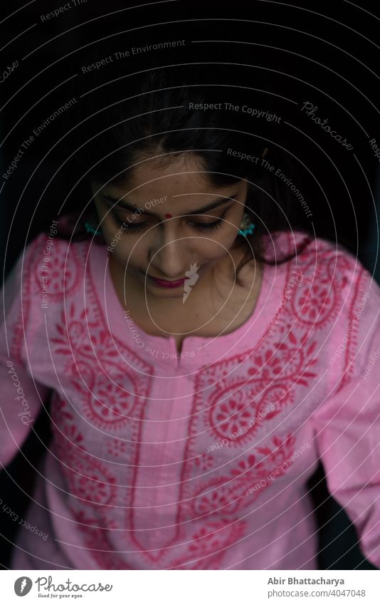 Indian teenage girl in pink dress standing on rooftop staircase asian conservative brunette hair black hair attractive young smile household background urban