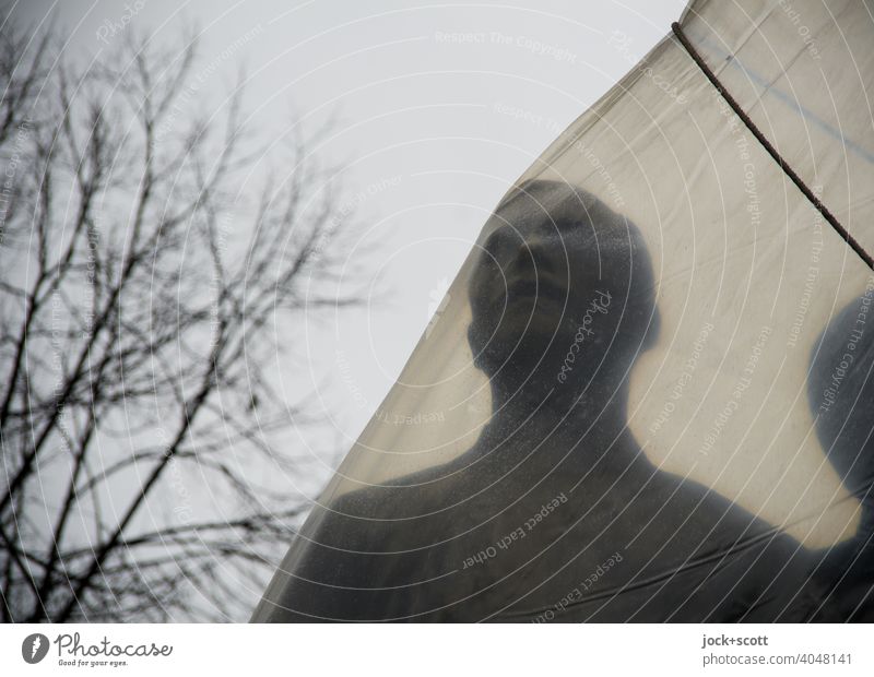 wrapped figure of the Vörösmarty monument Work of art Sculpture Tourist Attraction Budapest Monument Historic Transparent Encased in Subdued colour Shadow