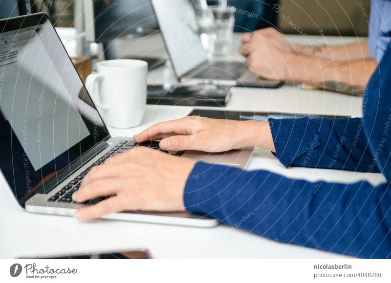 Employees working on laptop in office Sit Notebook Modern Work area Desk Cyberspace desktop Employees &amp; Colleagues Workplace Keyboard Computer Internet