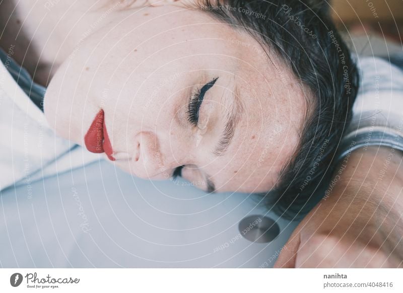 Portrait of a young woman leaning her face against a cold glass table depression blue sad mental health psychology sadness depressive white reflection mirror