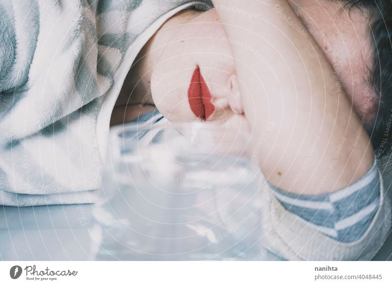 Portrait of a young woman hidden by a glass with a transparent drink depression blue sad mental health psychology sadness depressive cold white reflection