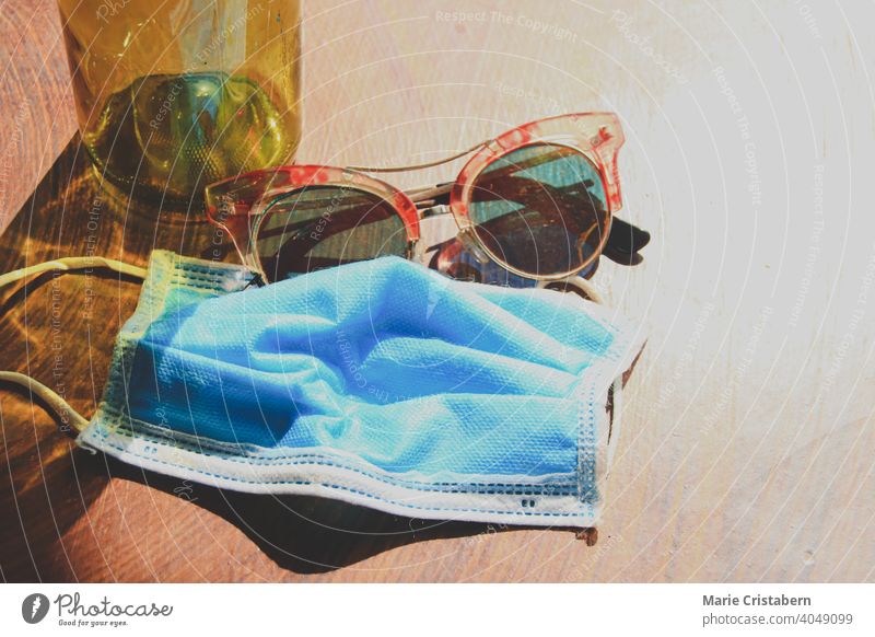 Medical mask and summer sunglasses to show the new normal lifestyle during summer new normal summer summer concept no people medical mask surgical mask covid-19