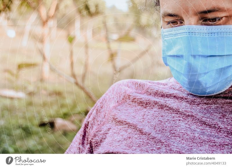 Close up of a man wearing headphones and a medical mask surgical mask close up new normal new normal lifestyle daily life coronavirus covid-19 pandemic epidemic