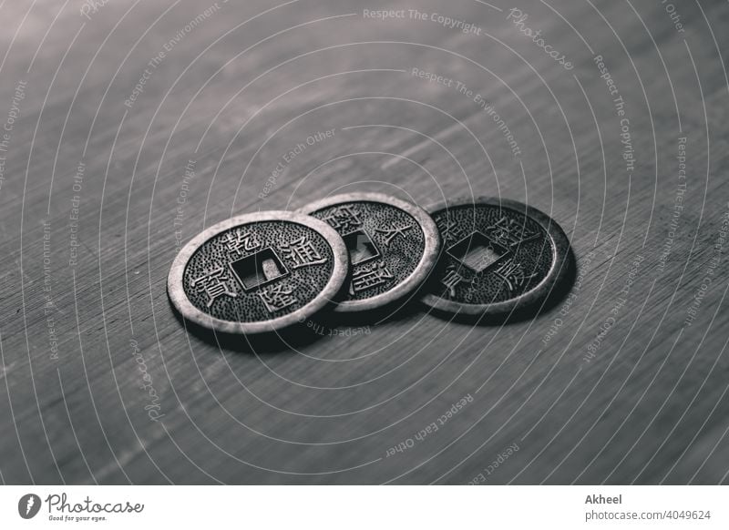 Traditional Chinese coins placed on a wooden board. Lucky Chinese Coins. Replica of ancient coins. antique asian background bank banking bronze business cash