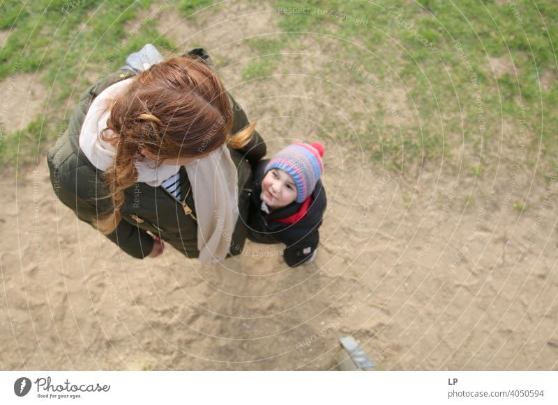 small child looking up toward his mother Upper body Dependability Exterior shot Help Love Together Safety (feeling of) Protection Trust Brave Self-confident